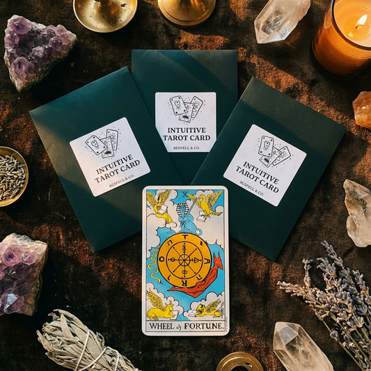 Intuitive Tarot Cards with 'Wheel of Fortune' card on a dark surface with crystals and candles.