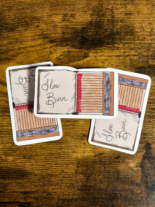 Matches with 'Slow Burn' text on a wooden surface