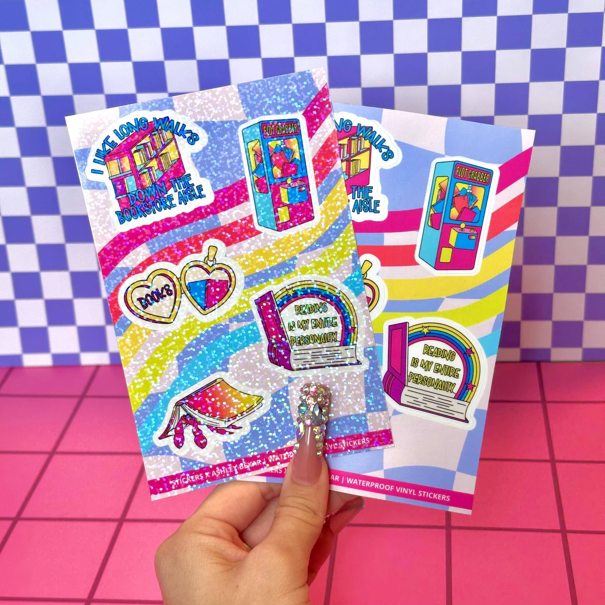 Colorful sticker sheet held by a hand on a checkered background