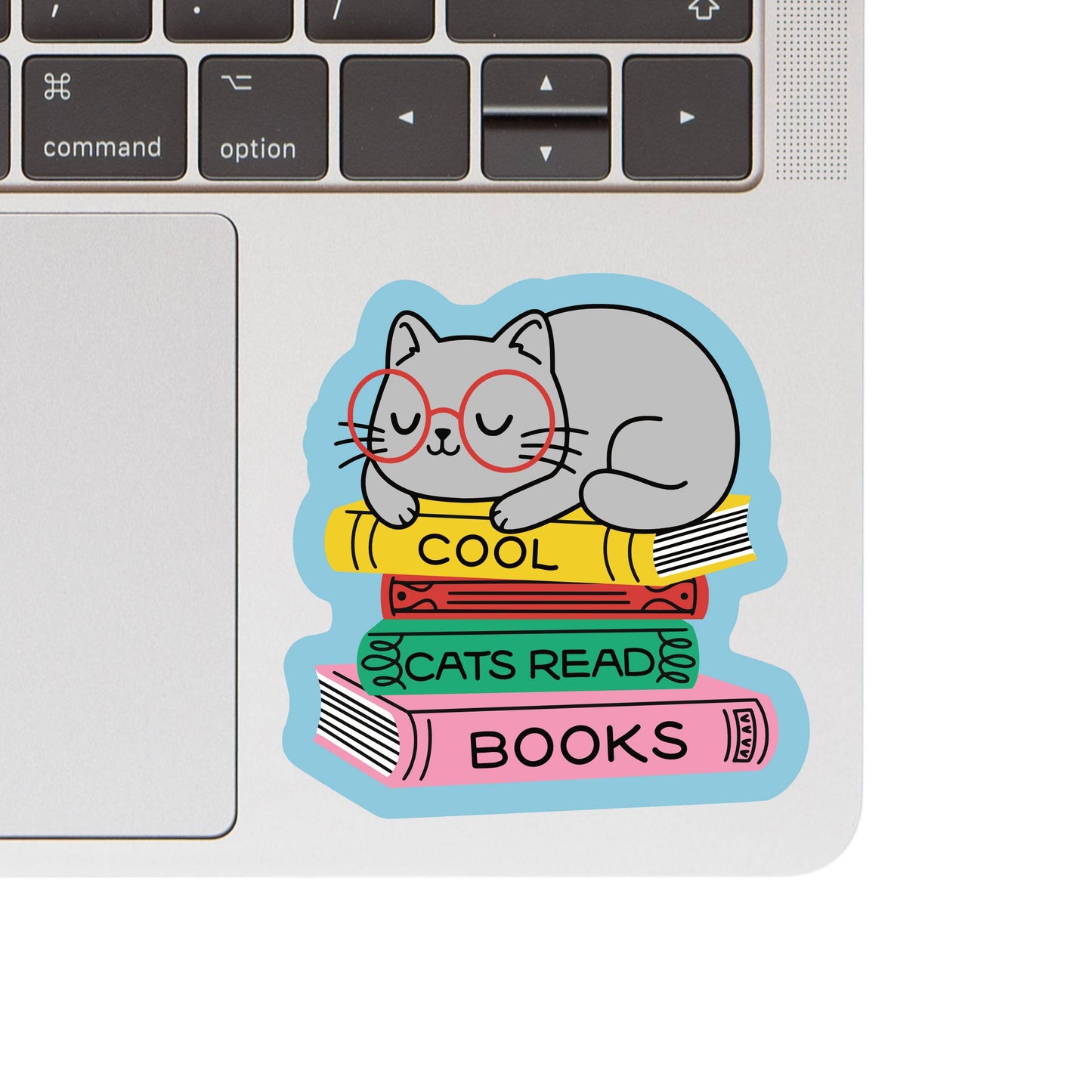 Laptop with a sticker of a cat reading books on the keyboard area