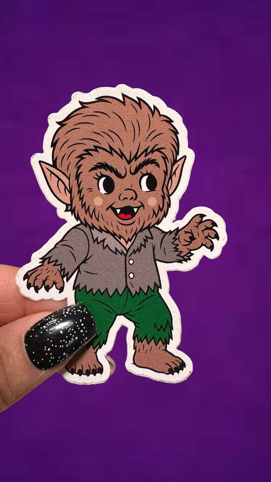 Cartoon-like creature sticker held by a hand against a purple background