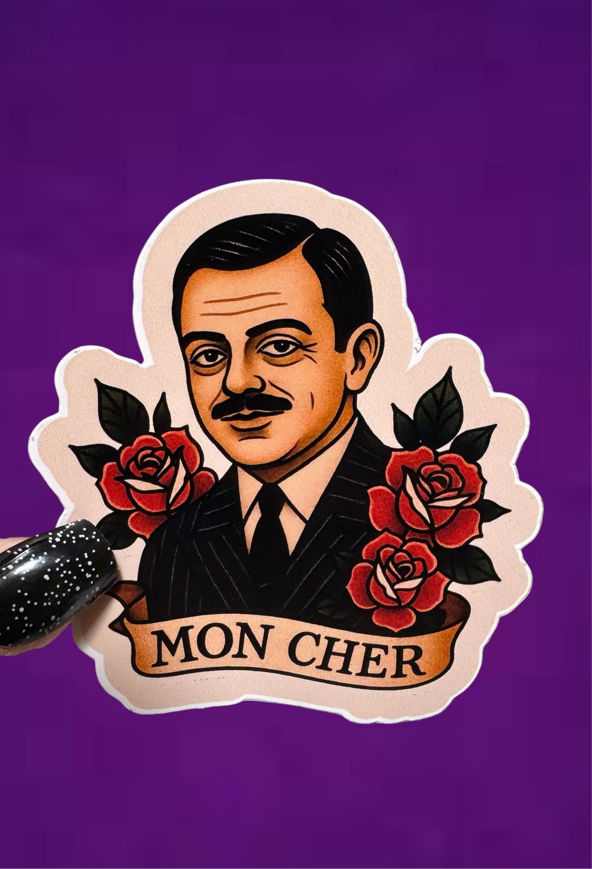 A die-cut sticker featuring a vintage-style portrait of a man in a pinstripe suit with red roses and a banner reading 'MON CHER', shown against a solid purple background.