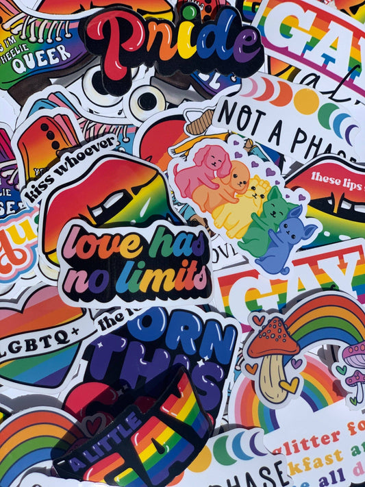 Collection of Pride-themed stickers with rainbow colors and LGBTQ+ symbols.