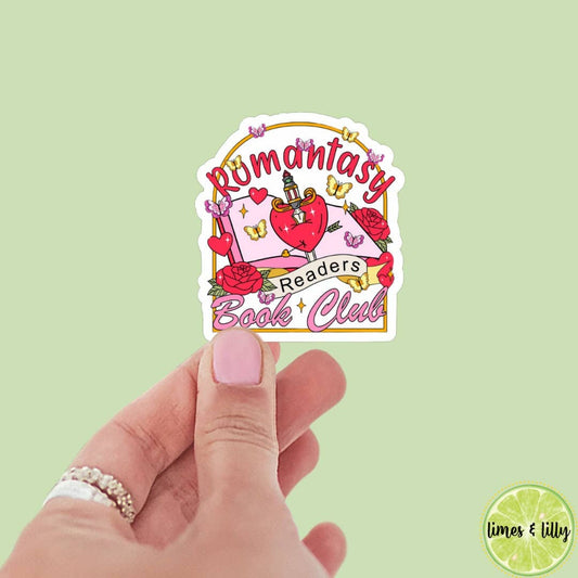 Sticker with 'Romantasy Readers Book Club' design held by a hand on a light green background