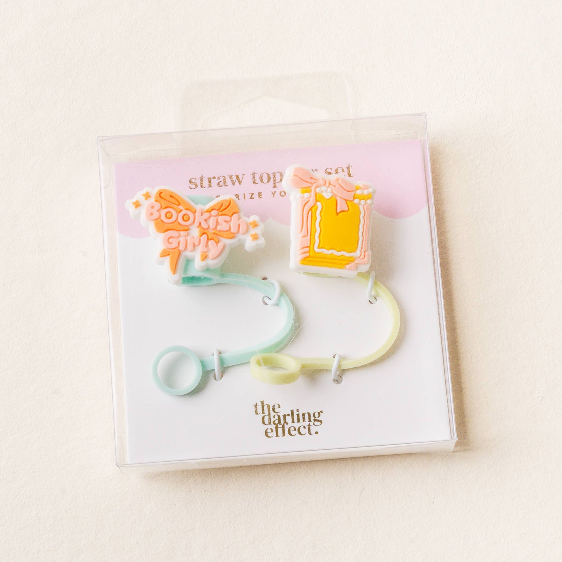Packaged straw top set with colorful design on a light background