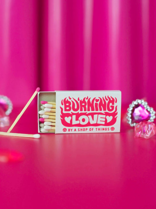 Matches with 'Burning Love' packaging on a pink background