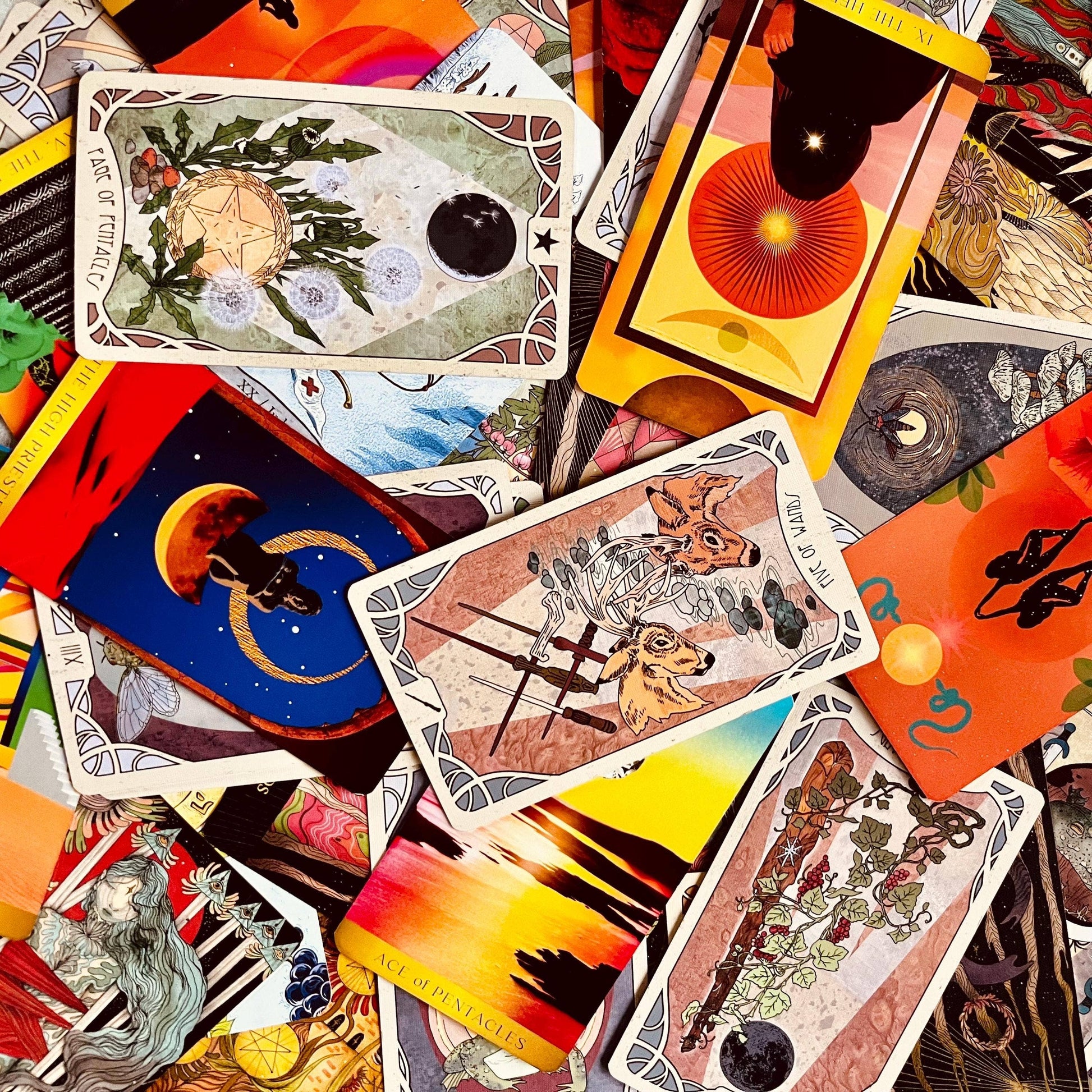 Collection of tarot cards with various designs and colors.