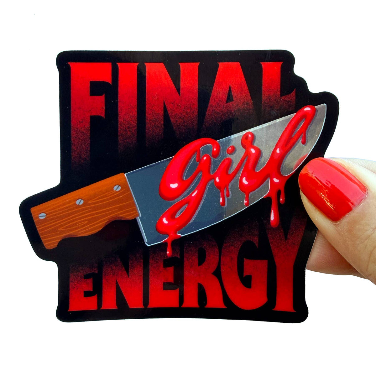 A die-cut sticker featuring the words 'FINAL ENERGY' in bold red letters with a black outline, overlaid with a silver knife graphic and dripping red script reading 'girl'. A hand with red nail polish holds the sticker against a plain white background.