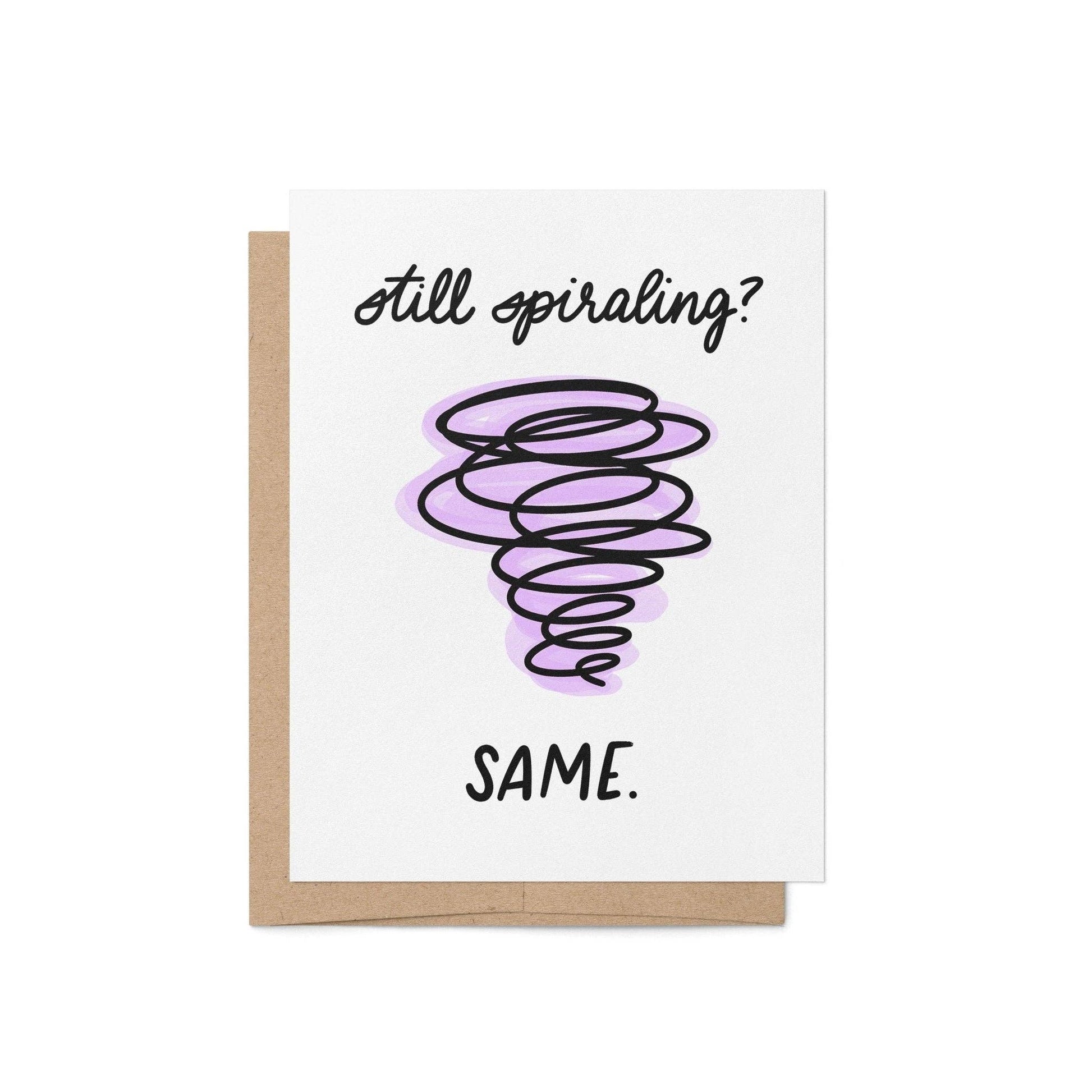 Greeting card with a purple spiral and text 'still spiraling? SAME.' on a white background.