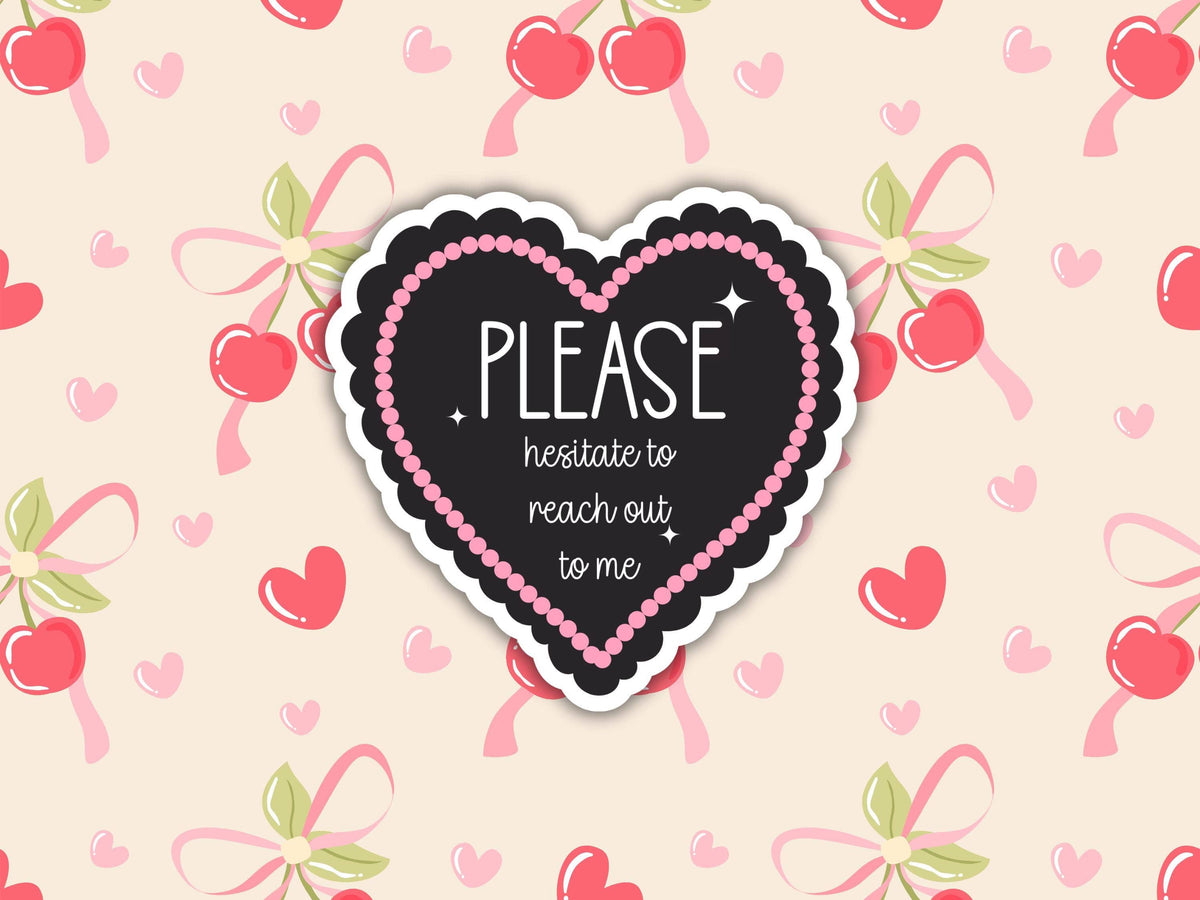 A heart-shaped sticker with a black chalkboard-style center, pink beaded border, and white text reading 'PLEASE hesitate to reach out to me,' shown on a light beige background with a repeating pattern of pink hearts, cherries, and bows.