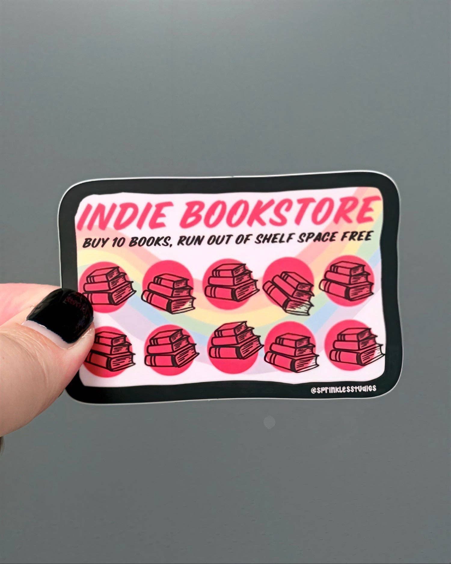 Sticker with 'Indie Bookstore' text and book illustrations on a gray background
