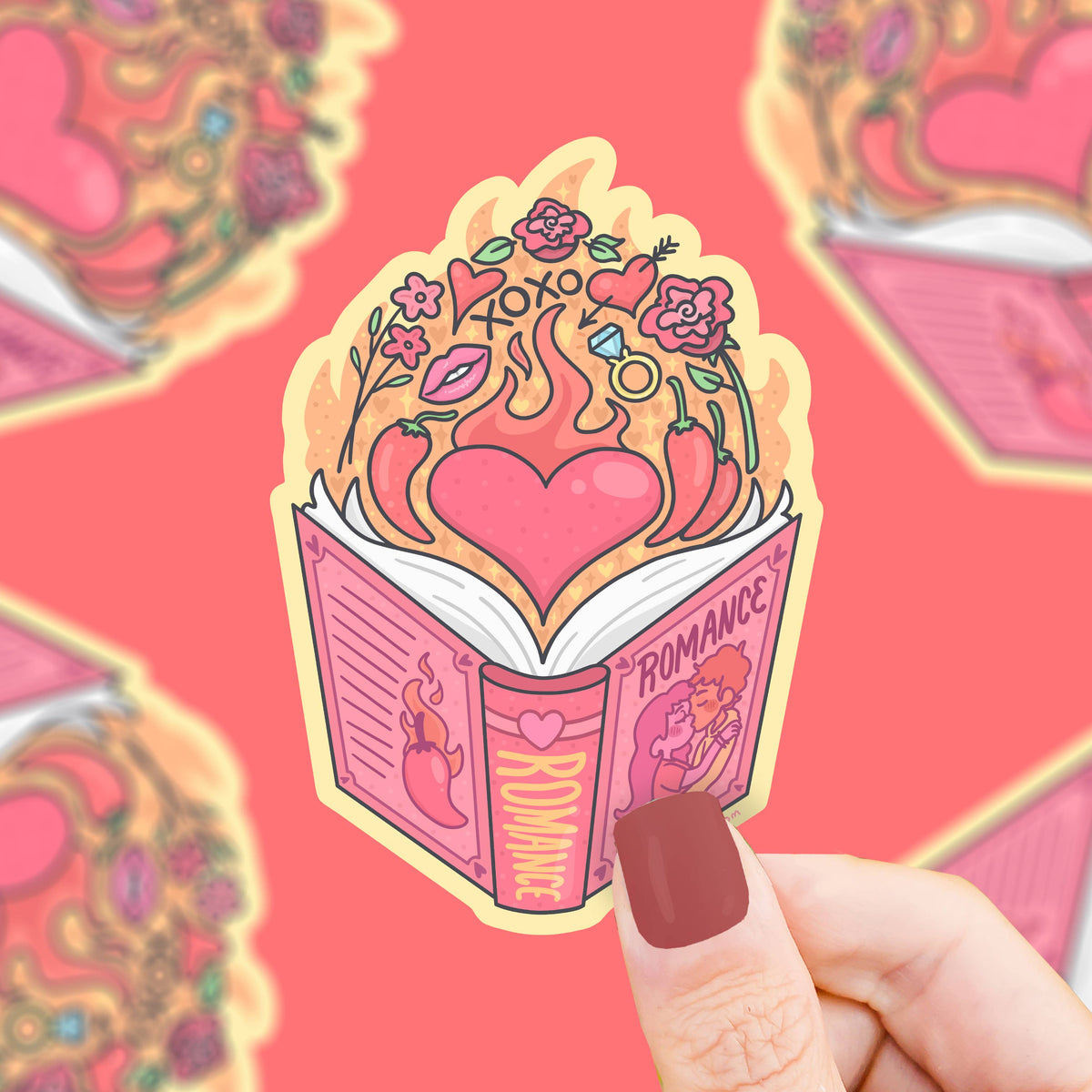 Sticker of an open book with a heart and romance theme held by a hand against a red background.