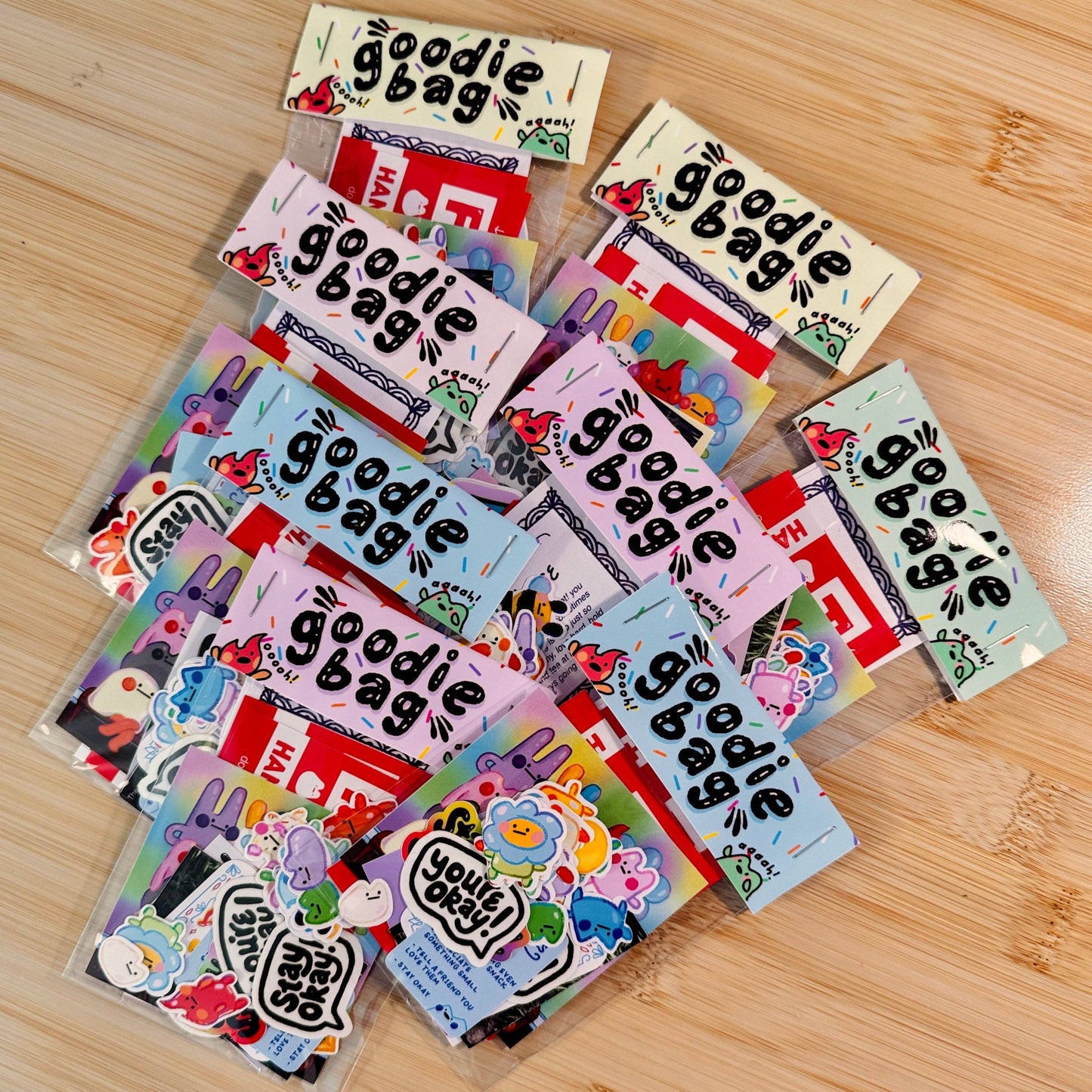 Collection of colorful 'goodie bag' packages on a wooden surface