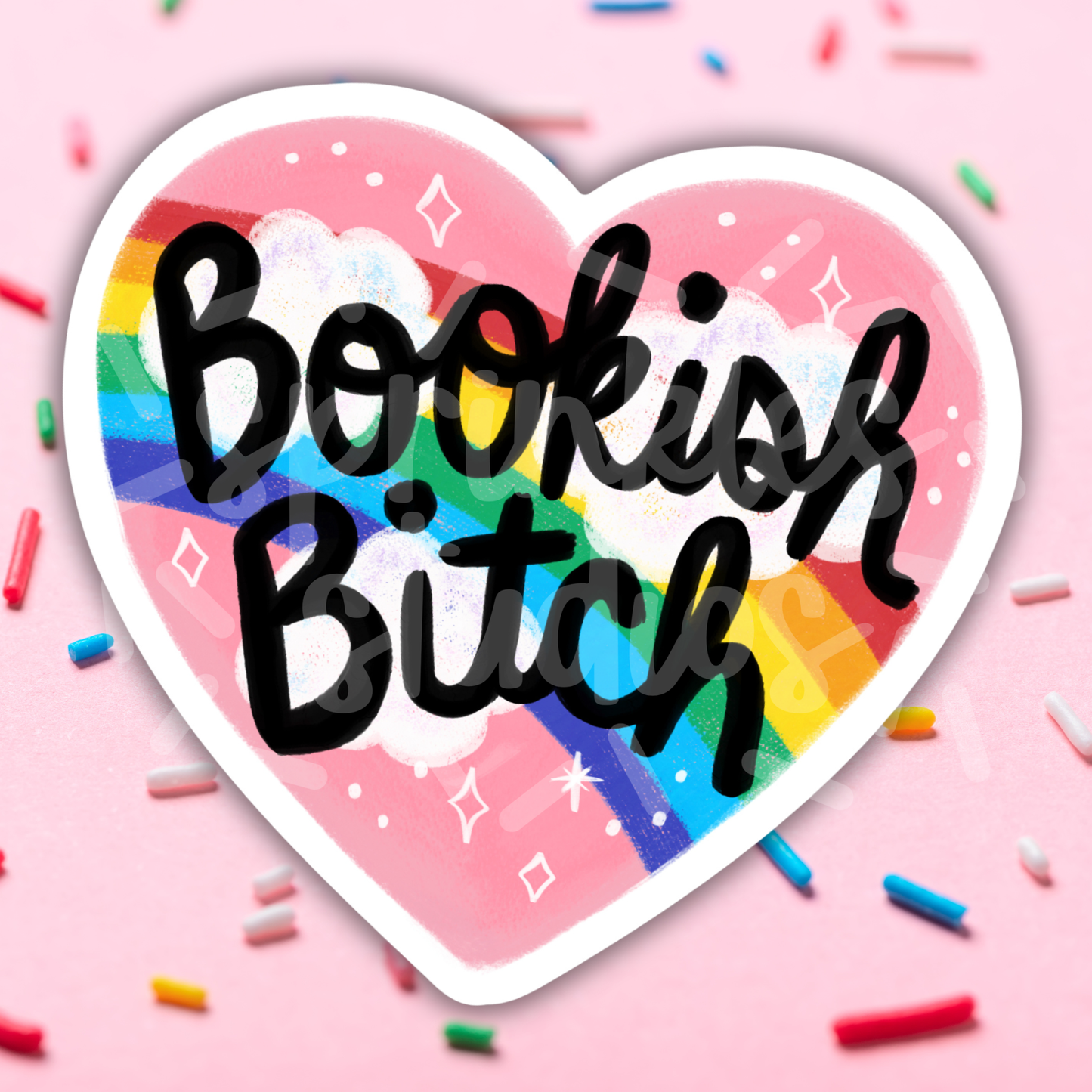 Heart-shaped sticker with 'Bookish Bitch' text on a pink background with rainbow colors and sprinkles.