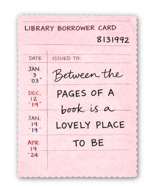 Pink library borrower card sticker with text 'Between the pages of a book is a lovely place to be' on a white background