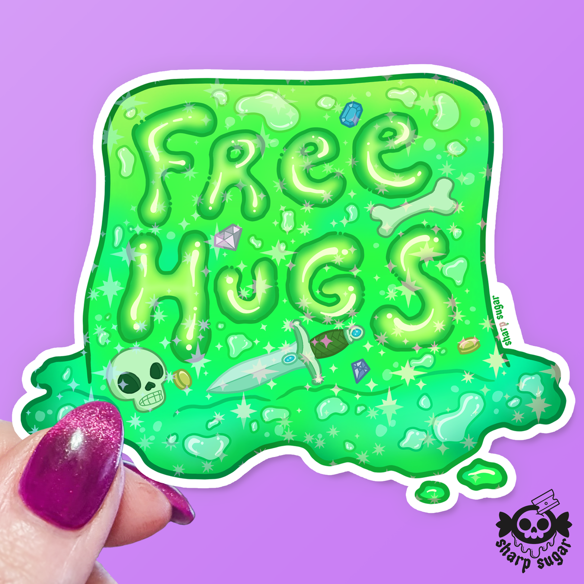 A die-cut sticker featuring the words 'Free Hugs' in bubbly green letters with small cartoon doodles including a skull, dagger, and gems, held by a hand with glittery purple nail polish against a solid purple background. A 'sharp sugar' brand logo is visible in the bottom right corner.
