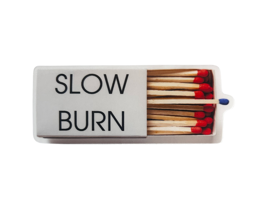 Matchbox with 'SLOW BURN' text and matches inside on a white background