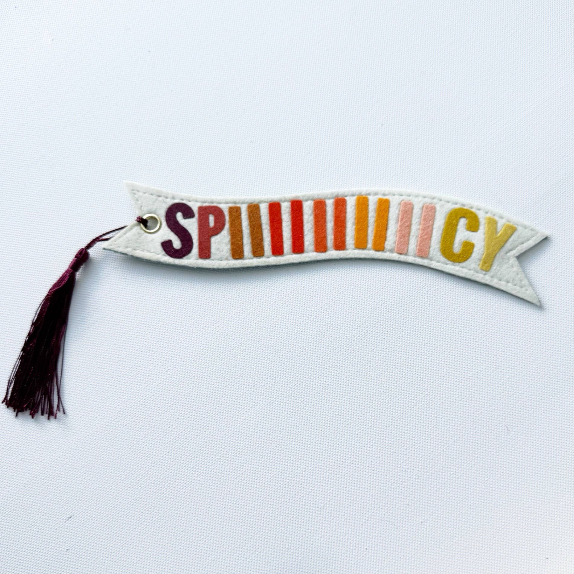 Decorative banner with colorful letters spelling 'SPICY' on a white background
