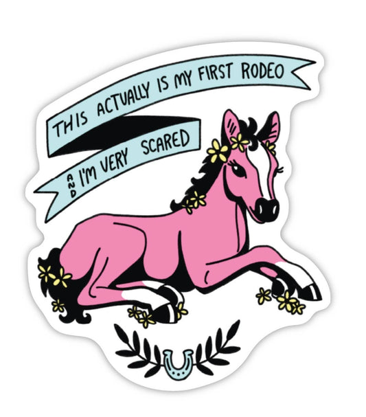 Sticker with a pink horse and text 'This actually is my first rodeo & I'm very scared' on a white background