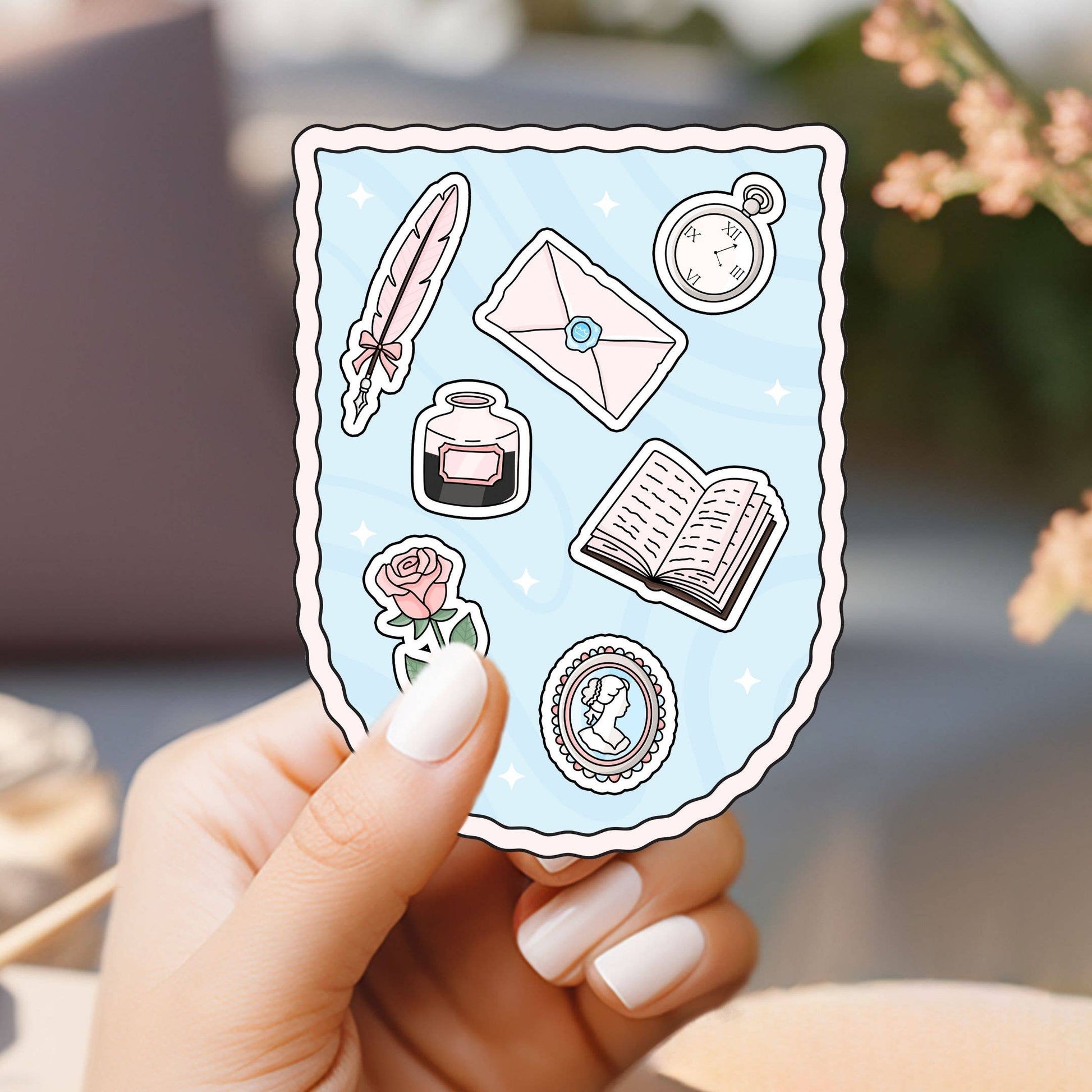 Hand holding a sheet of decorative stickers with literary-themed designs.