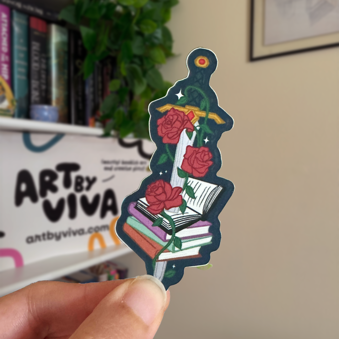 Decorative sticker with roses and books held by a hand, with 'Art by Viva' in the background.
