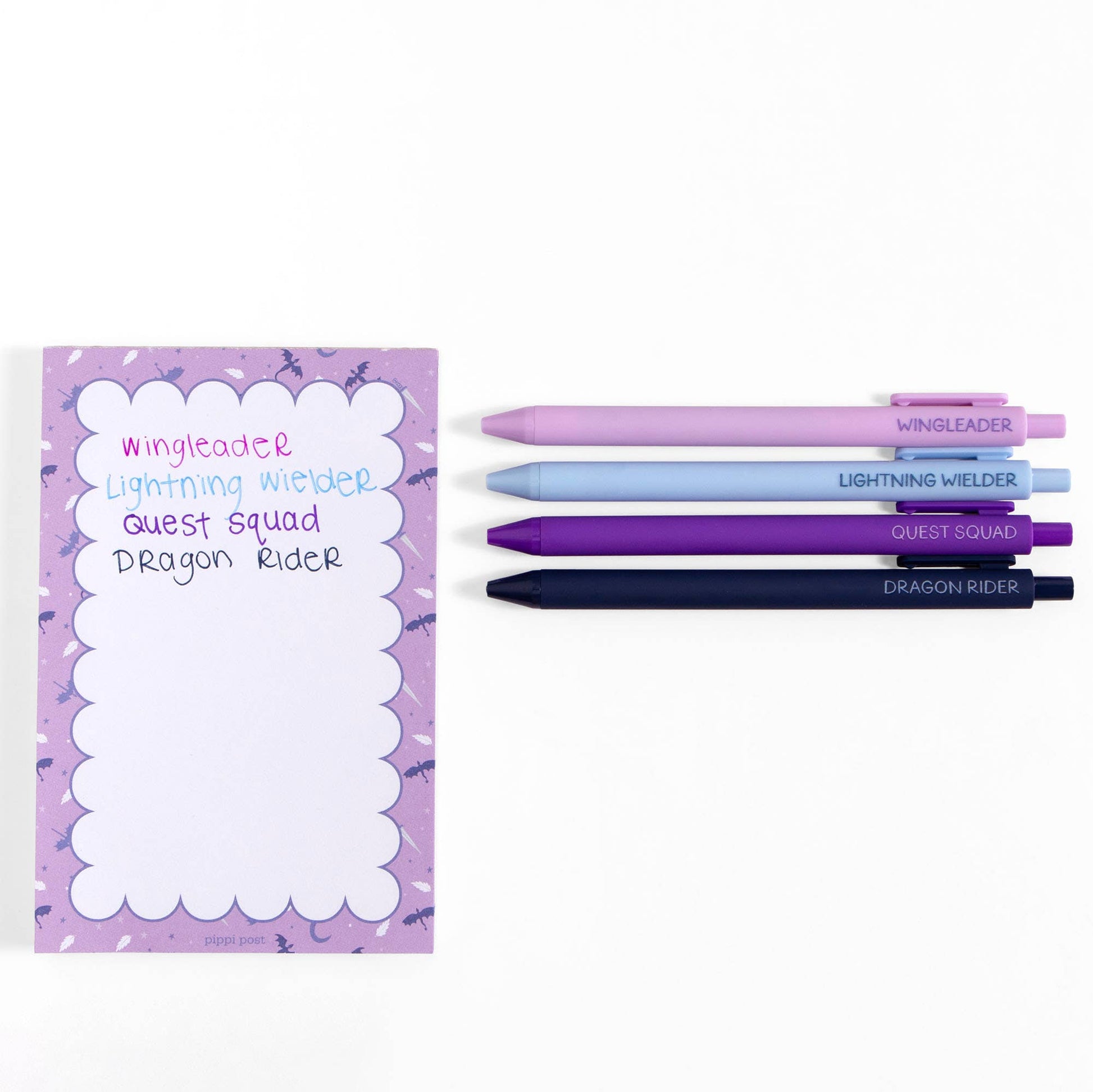 Purple notepad with writing utensils on a white background