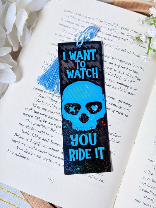Bookmark with skull design and text on an open book