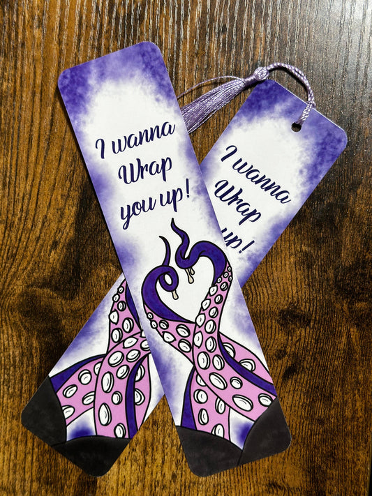 Pair of socks with peacock design and text on a wooden surface
