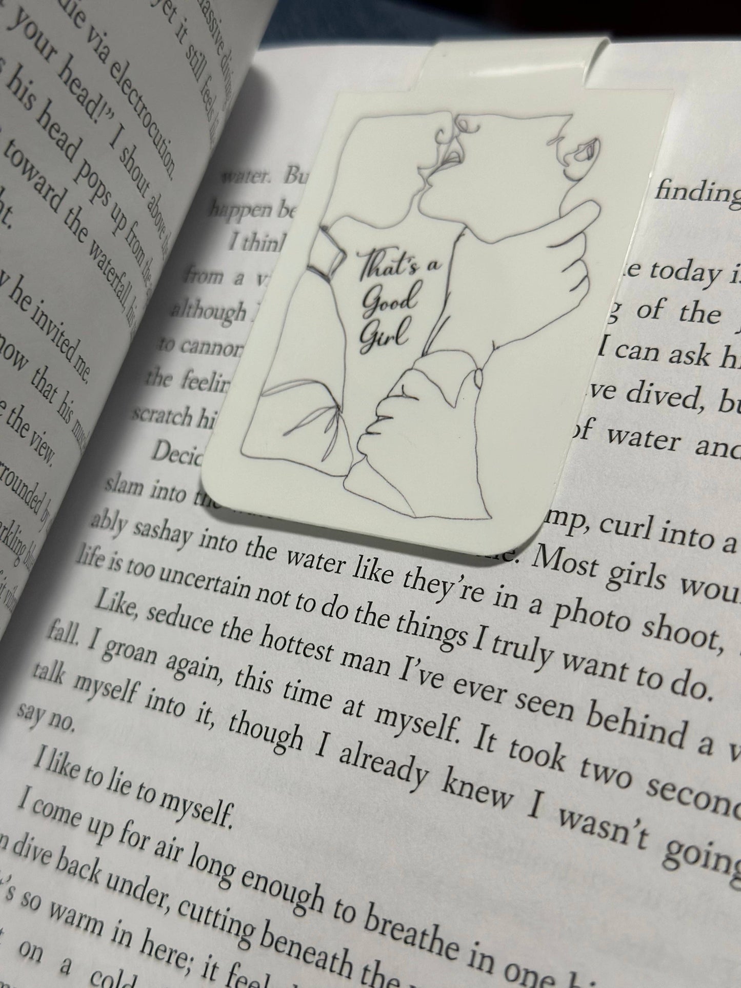 Illustrated bookmark with text 'That's a Good Girl' on an open book