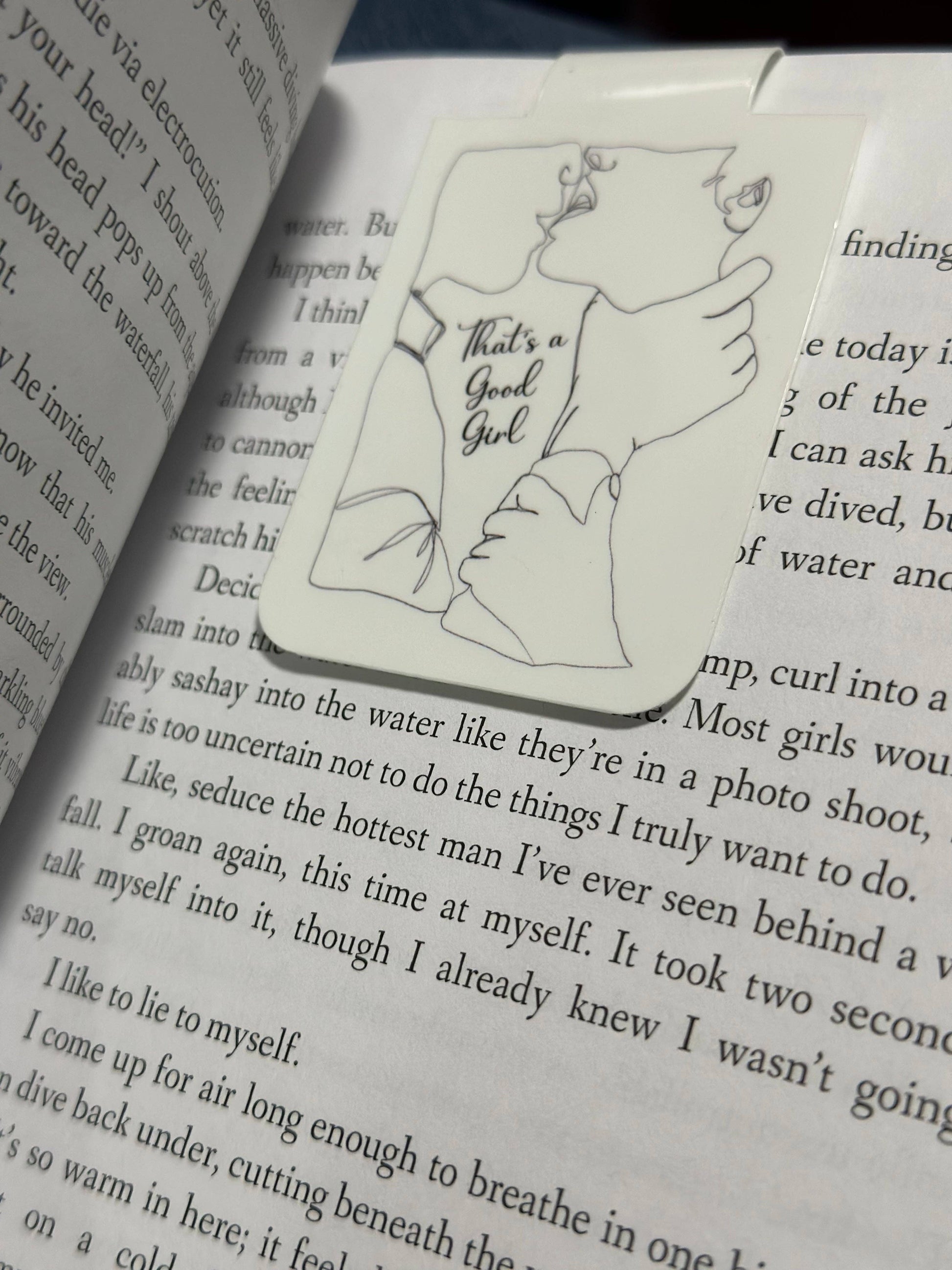 Illustrated bookmark with text 'That's a Good Girl' on an open book