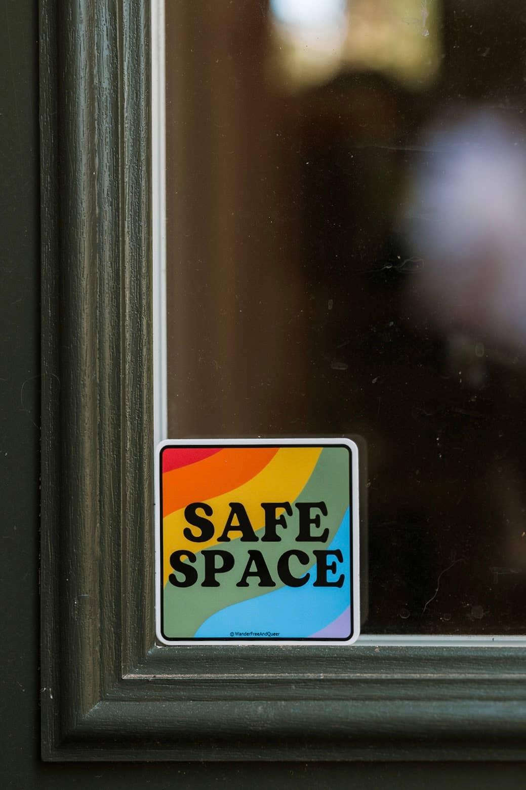 Rainbow 'Safe Space' sticker on a glass door