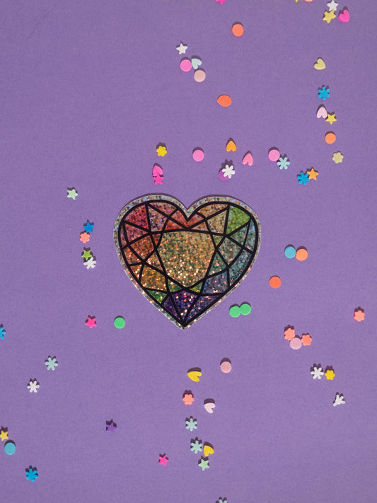 Colorful heart design on a purple background with confetti-like shapes.