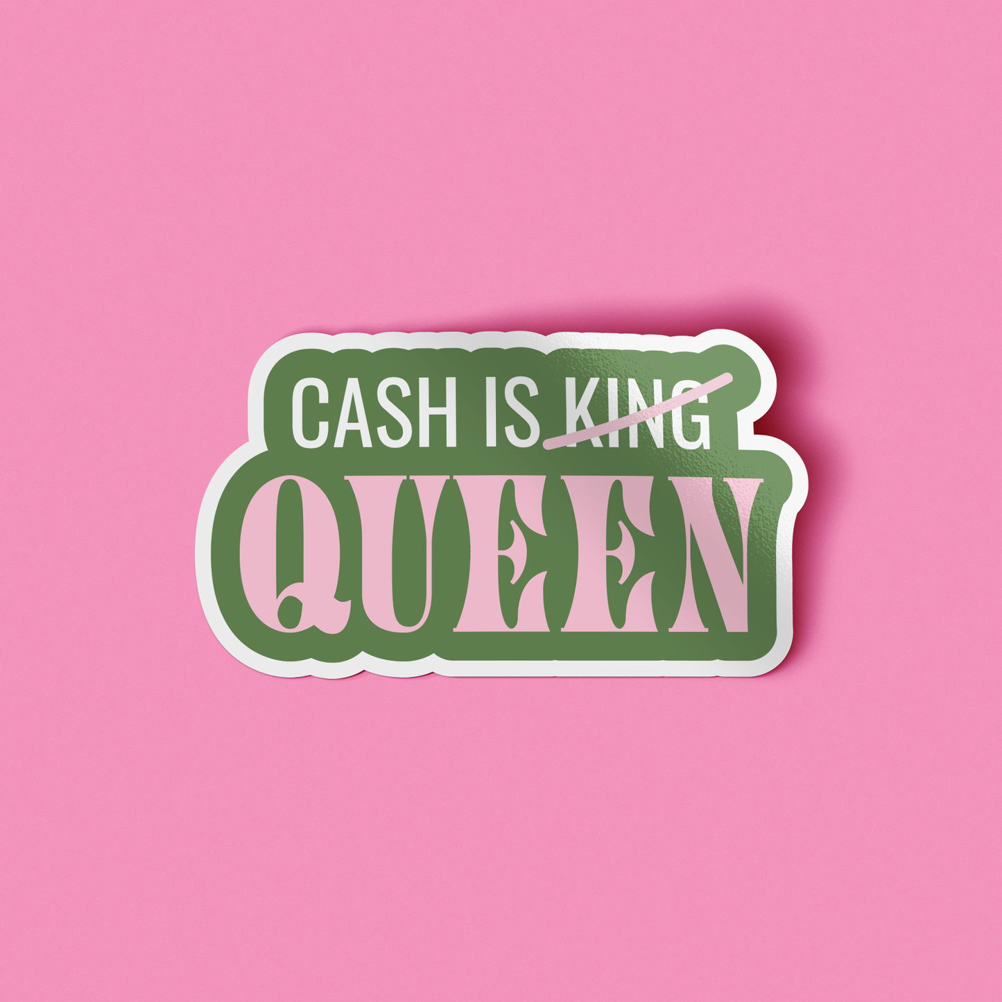 A die-cut sticker with the text 'CASH IS KING' crossed out in pink and 'QUEEN' underneath in large pink letters with green outlines, shown on a solid pink background.