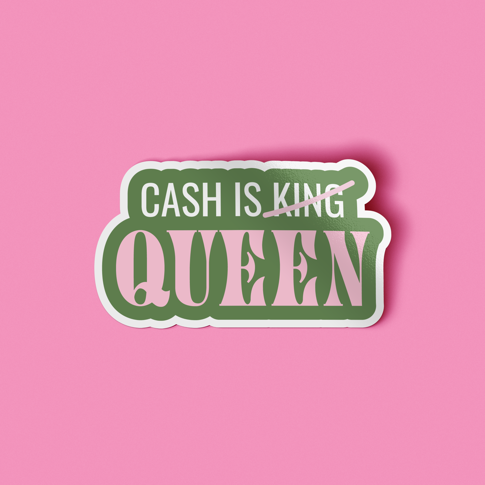 A die-cut sticker with the text 'CASH IS KING' crossed out in pink and 'QUEEN' underneath in large pink letters with green outlines, shown on a solid pink background.