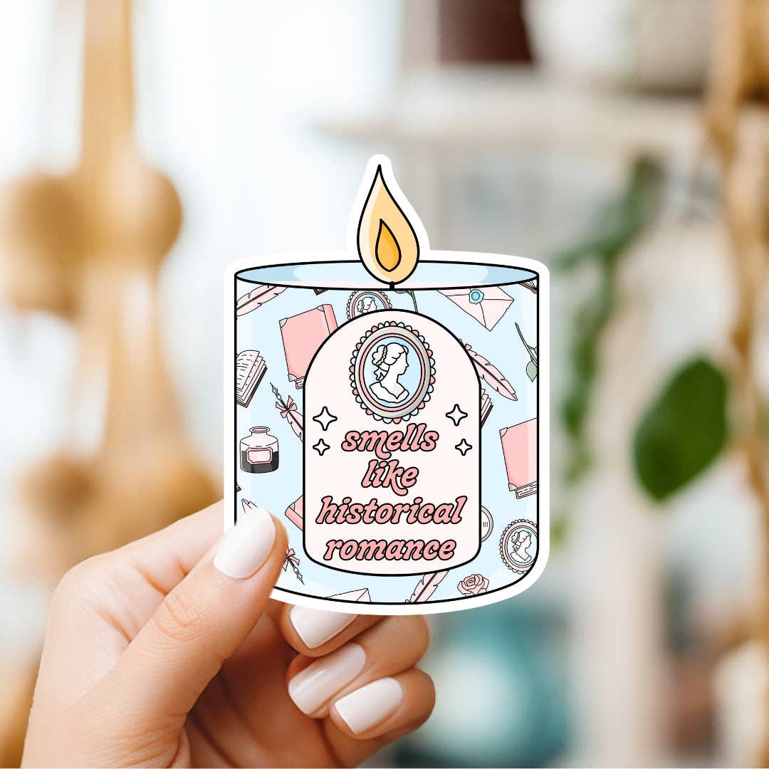 Sticker of a candle with 'smells like historical romance' text held by a hand.