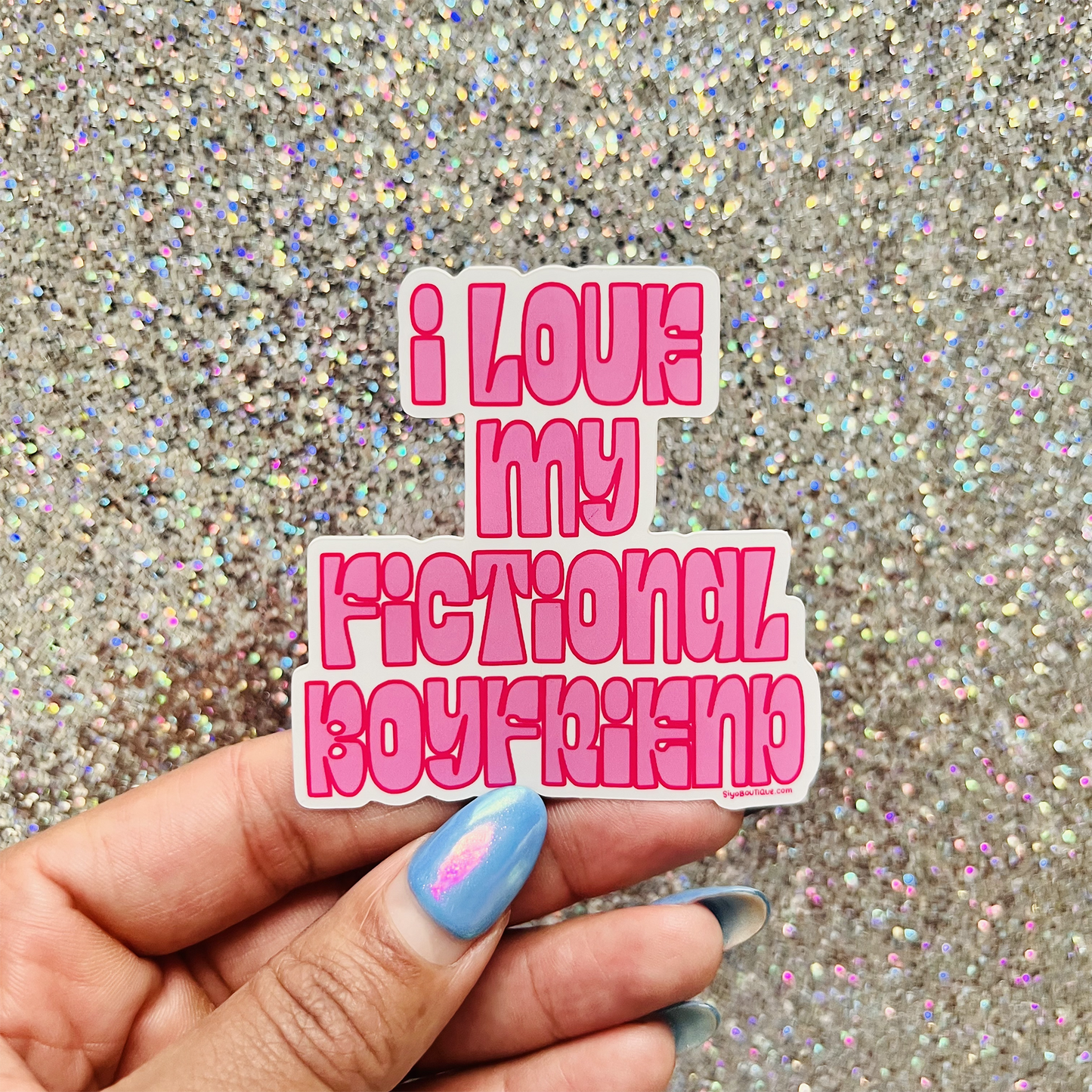 Sticker with 'I love my fictional boyfriend' text held over a glittery background