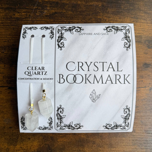 Crystal bookmark packaging with clear quartz stones on a wooden surface