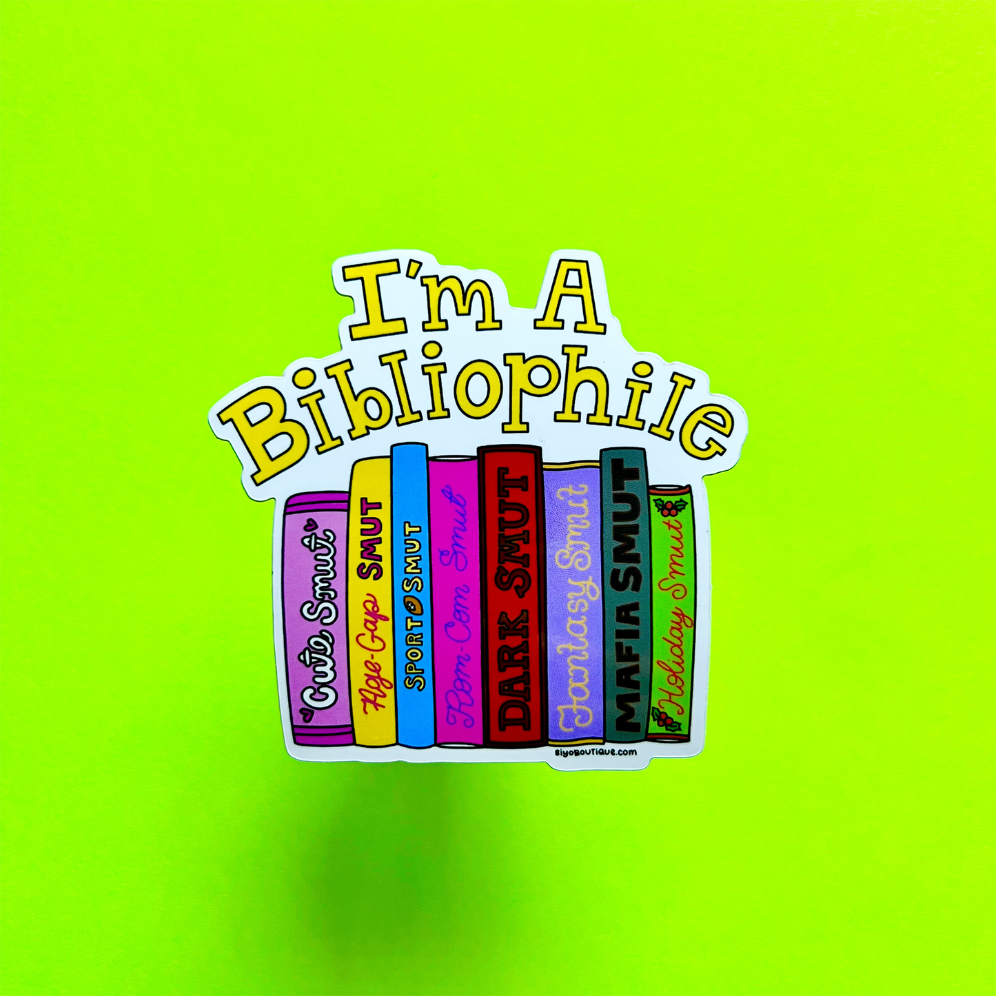 Sticker with colorful books and 'I'm A Bibliophile' text on a bright green background