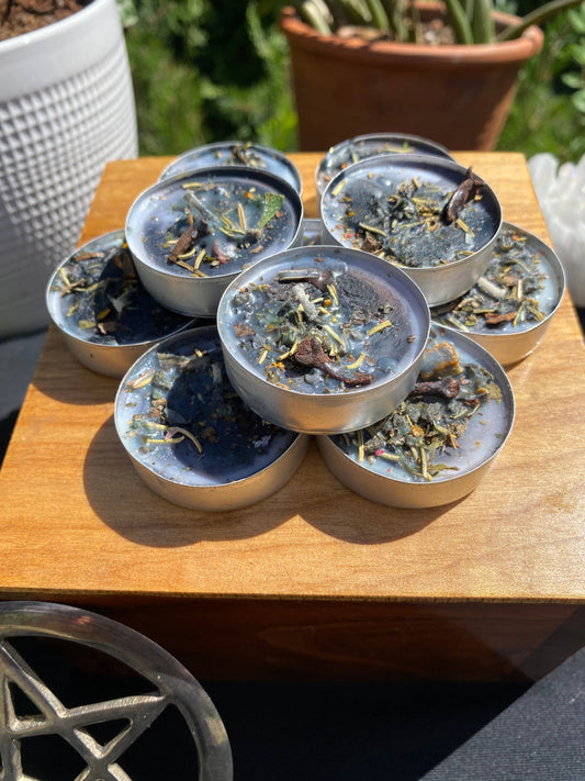 Set of small candles with a natural product on a wooden surface outdoors