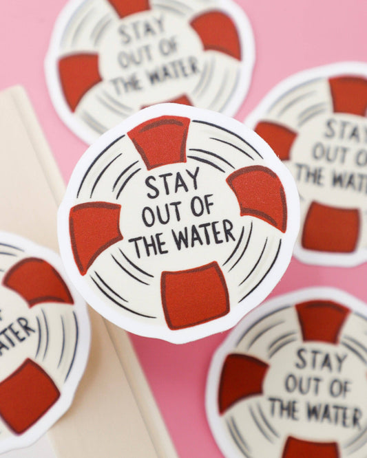Sticker with 'Stay Out of the Water' text on a pink background