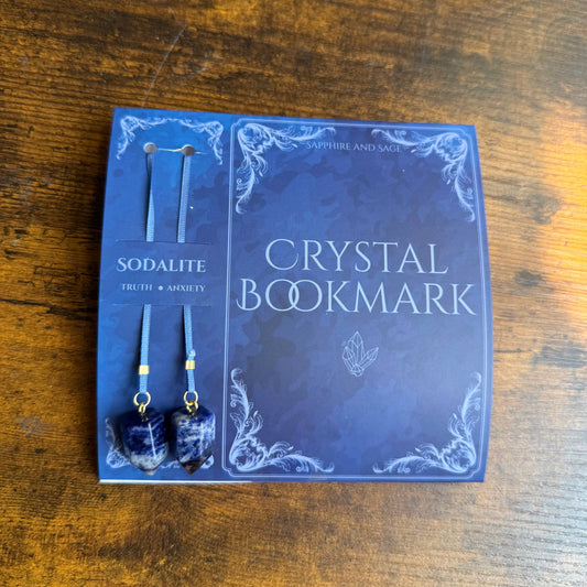 Crystal bookmark and earrings set on a wooden surface