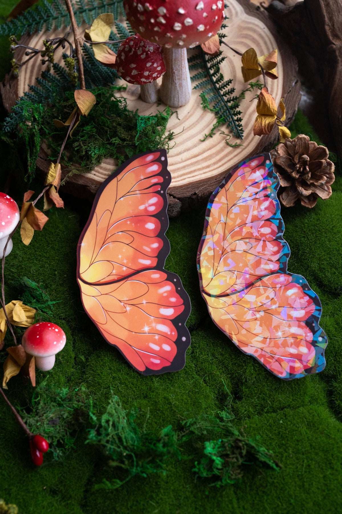 Butterfly wings with a gradient of orange to pink on a green surface with decorative elements.