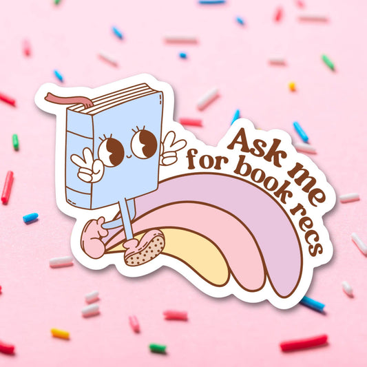 Sticker with a cartoon book character on a pink background with sprinkles.