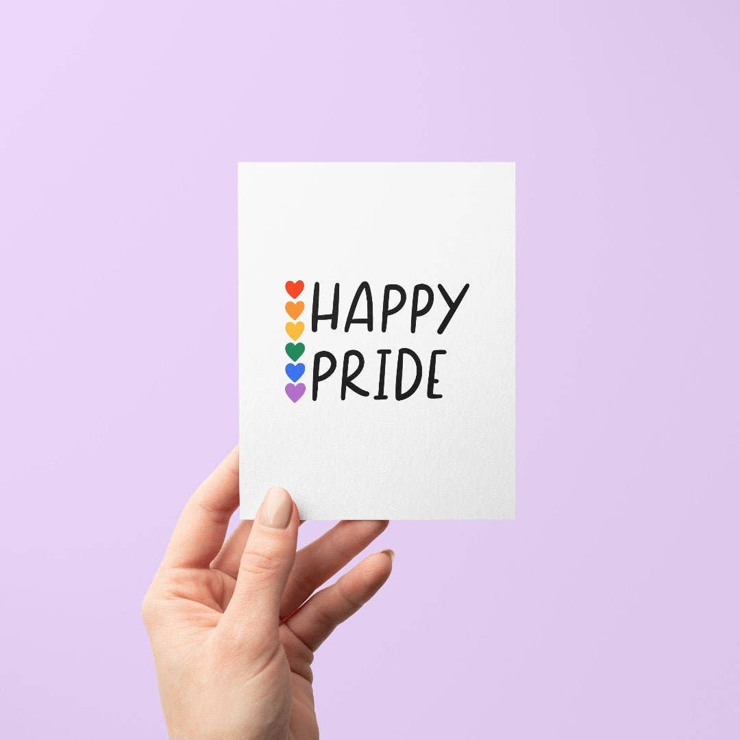 Hand holding a card with 'Happy Pride' text and rainbow hearts on a purple background