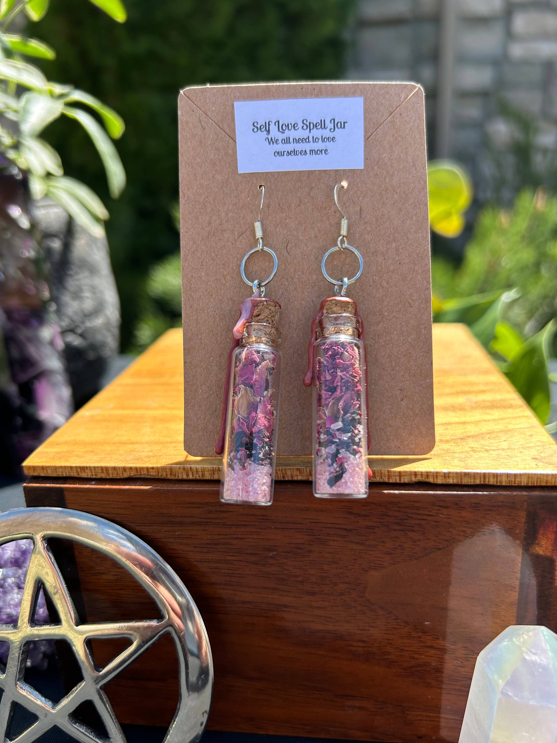 Pair of earrings on a backing card with a natural background