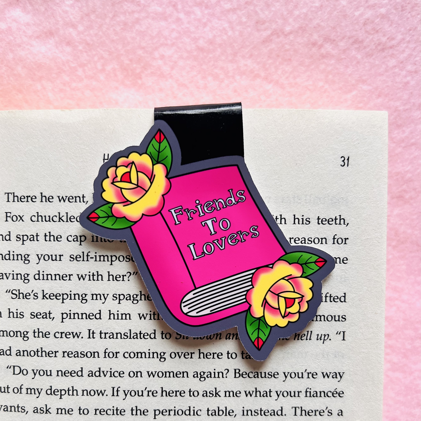 Book-shaped magnet with 'Friends To Lovers' text on a page, surrounded by pink and yellow roses.