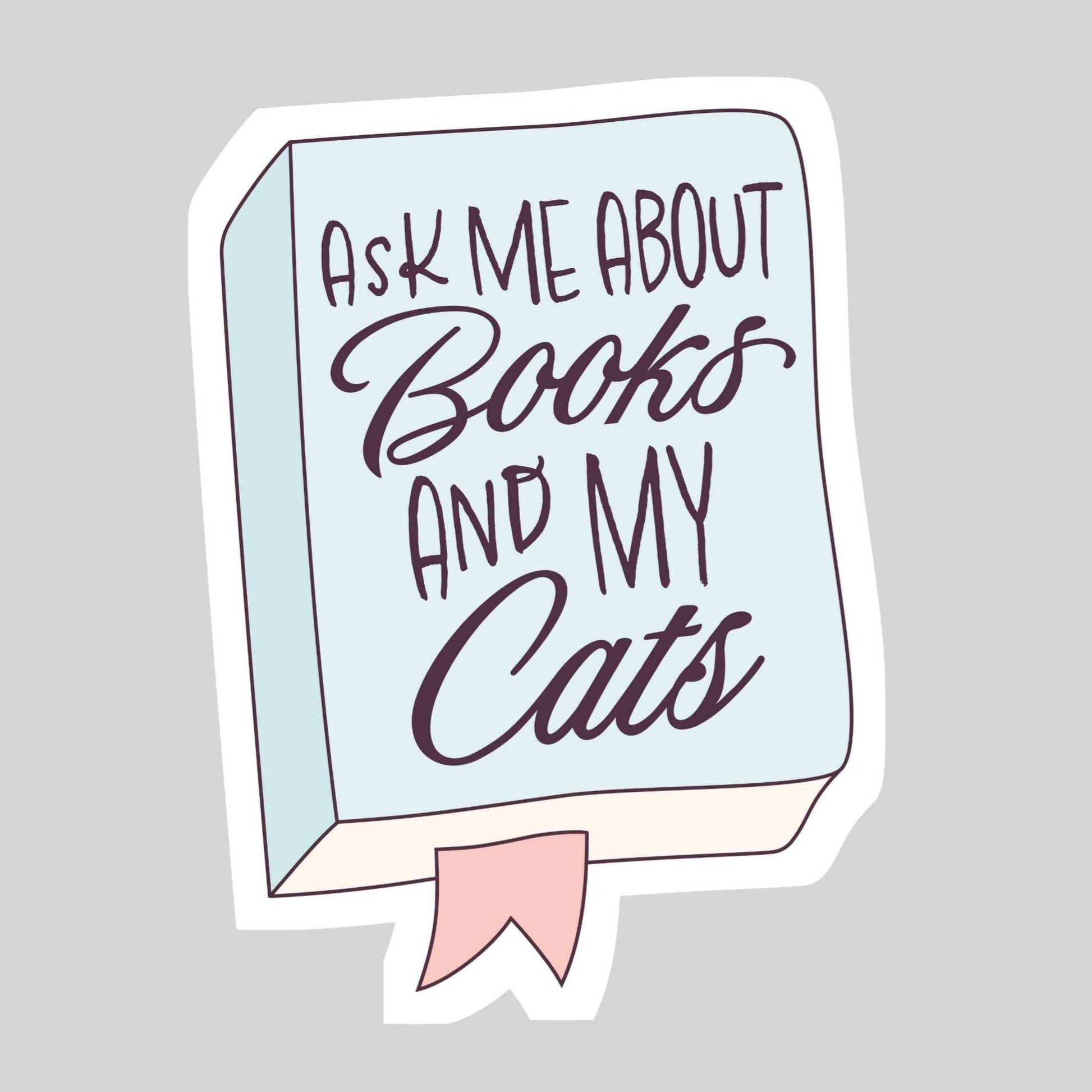 Sticker with text 'Ask me about books and my cats' on a light blue background with a pink ribbon.