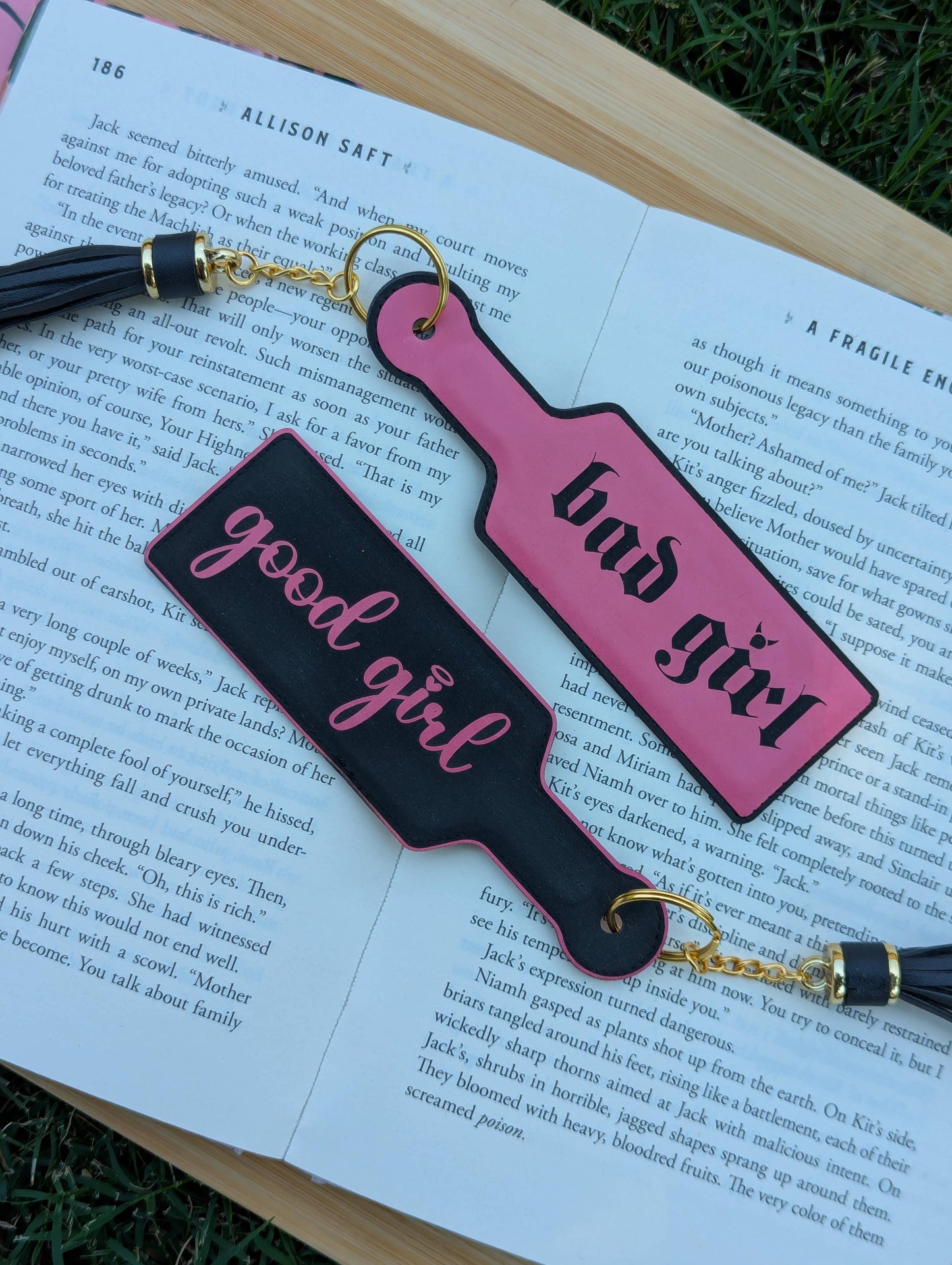 Bookmarks with 'good girl' and 'bad girl' text on an open book.