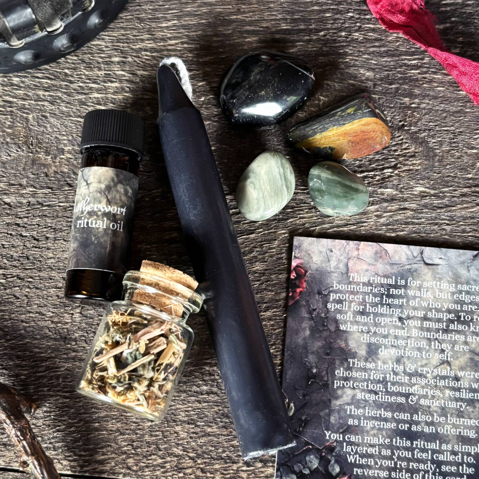 Vibrating wand, essential oil bottle, and crystals on a wooden surface with text card.