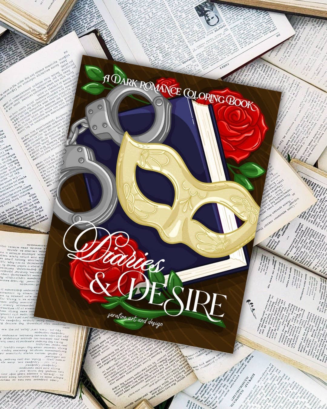 Coloring book titled 'Diaries & Desire' on top of books with handcuffs, mask, and roses.